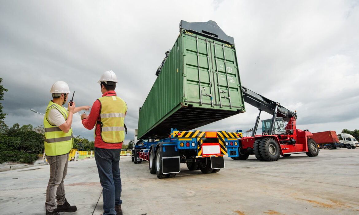 forklift lifting on the container to the trailer in yard, under foreman control in charge